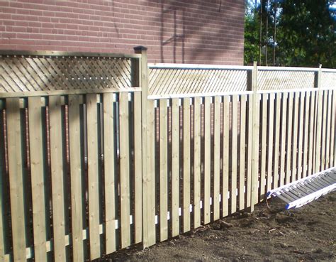 An uninterrupted line of boards stretches as far as the fence line runs with supporting posts. Wooden Fences » Tropical Touch Landscaping