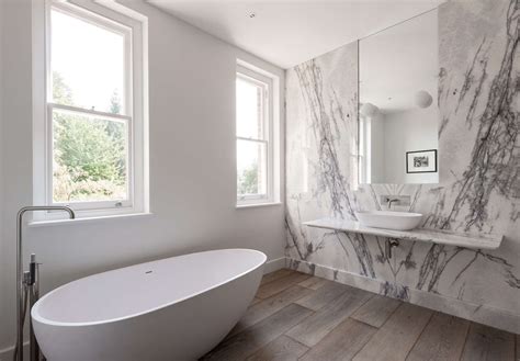 White marble tiles on bathroom walls having soft veins along with colors creating bright and open aura gives an exotic feeling to the shower area. Bathroom of the Week: In London, a Dramatic Turkish Marble ...