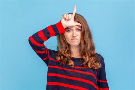 Woman Showing Loser Gesture L Finger Sign On Forehead Upset About