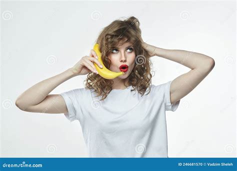 Attractive Girl Holds A Banana In Her Hands And Pretends To Call