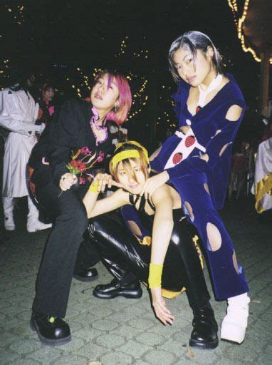 Three People In Costumes Posing For The Camera