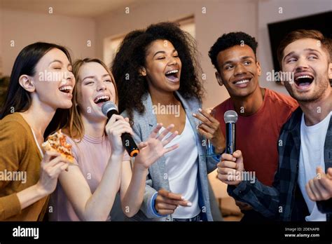 Sing It Enthusiastic Group Of Friends Singing With Microphone While