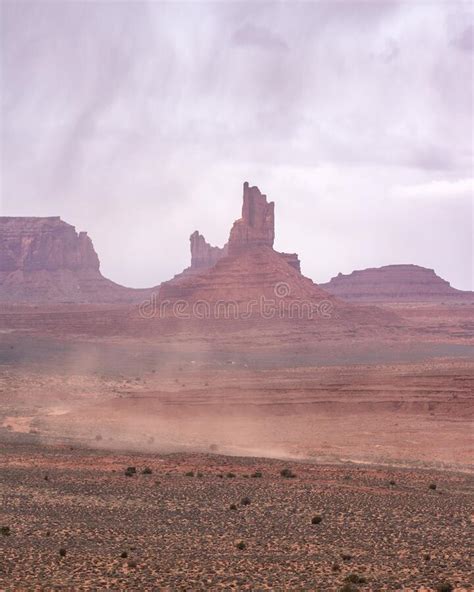 Dust Storm Sweeping Across A Desert Landscape Filled With Rock