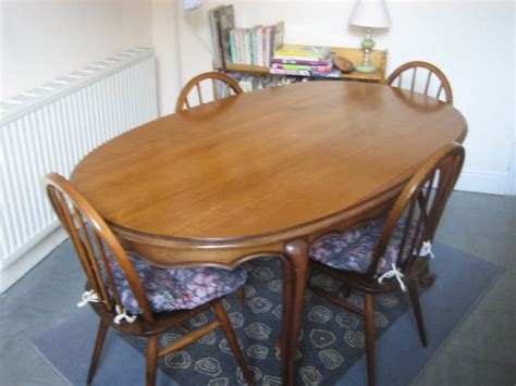 They have grand, distinctively shaped back and fabric upholstery in a soft almond colour. Set of Ercol chairs and Oval Solid Wood Dining Table For ...