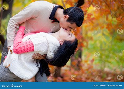 Photo Of Cute Couple Kissing On The Wonderful Autumn Park Background