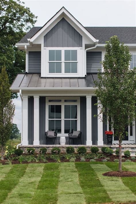 Grey Home Exterior With Grey Board And Batten Siding And White Trim