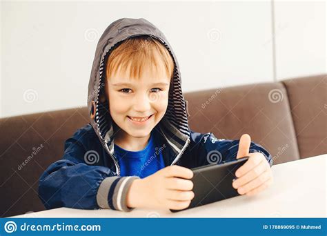 Happy Boy Playing Games On Mobile Phone Kid Watching Videos On