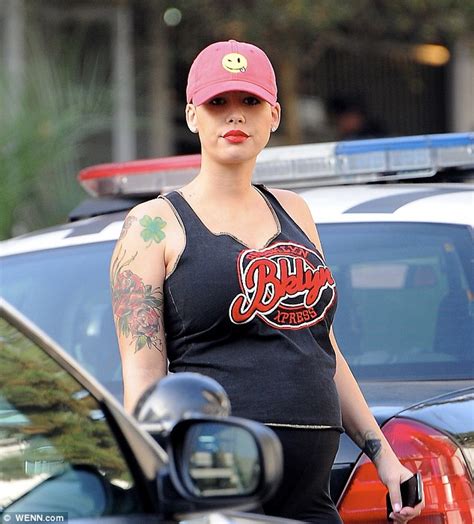 Pregnant Amber Rose Turns Heads In Leggings And Bright Pink Coat On Outing With Fiancé Wiz