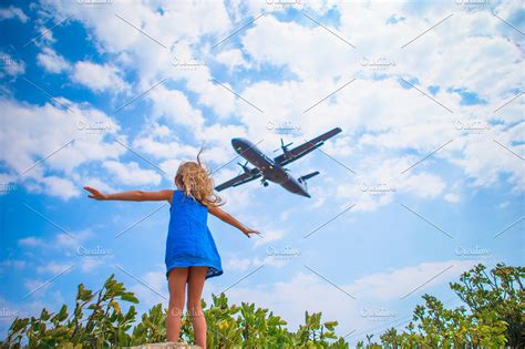 Adorable Little Child Girl Looking To The Sky And Flying Plane Directly