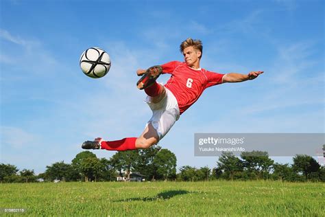 Soccer Player Kicking The Ball In Midair High Res Stock Photo Getty