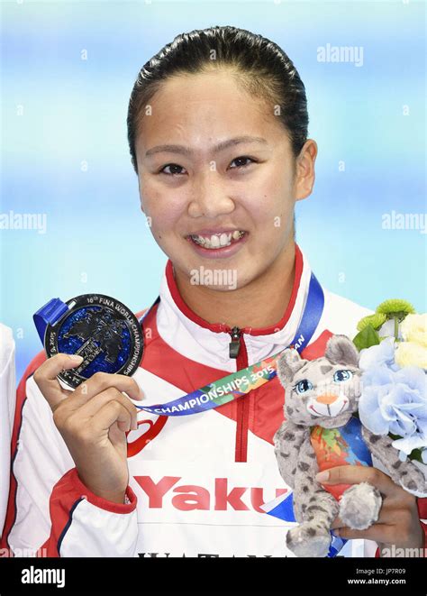 japanese swimmer kanako watanabe poses for photos with her silver medal after the women s 200