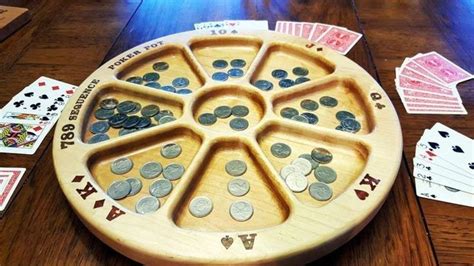 A Wooden Board Game With Playing Cards And Coins
