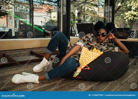 Woman Lying On Black Bean Bag Chair Near Cafe Picture Image 112669708