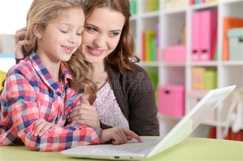 Portrait Of Happy Mother And Daughter Using Laptop Together Stock Image
