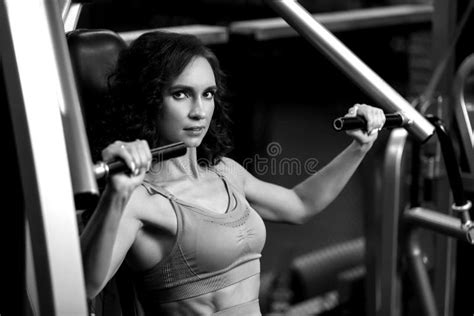 Fitness Brunette Girl Is Sitting On Training Apparatus And Posing Bw Stock Image Image Of