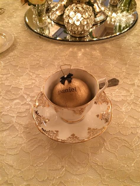 A Tea Cup With An Ornament In It Sitting On A Table