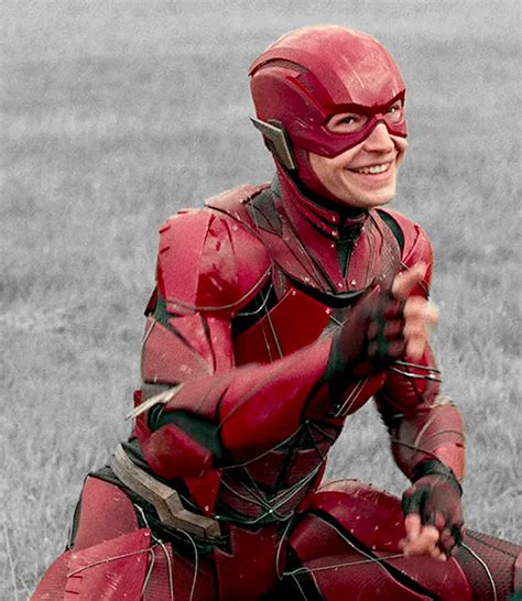 A Man Dressed As The Flash Sitting In A Field