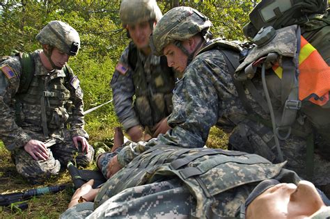 Us Army Soldiers Apply A Field Dressing Bandage To A Wound During The