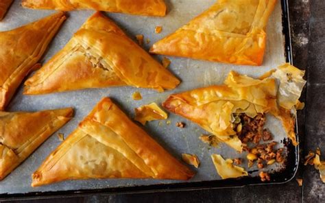 Spread spinach and cheese mixture into pan and fold overhanging dough over filling. Rick Stein's spiced lamb filo pastries with pine nuts