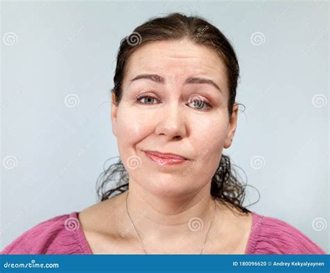 Adult Woman With A Grin On Her Face Portrait On Grey Background