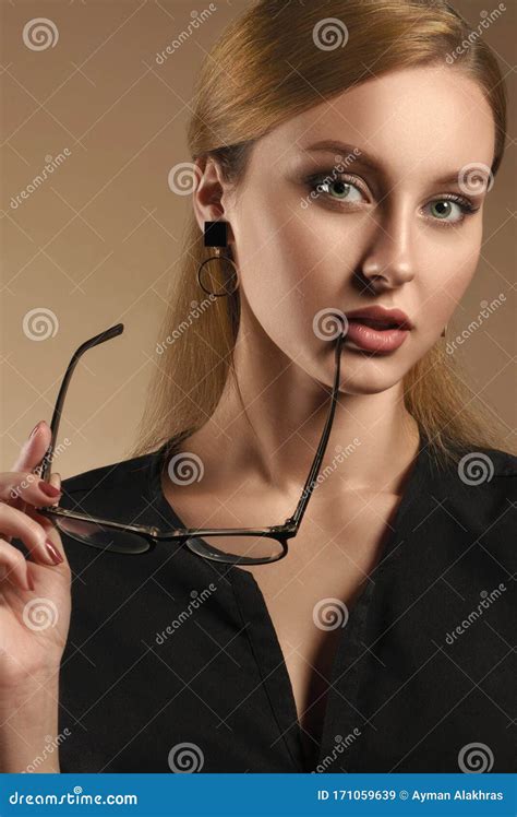 Vertical Portrait Of Pretty Girl Taking Eye Glasses Off And Wearing Black Shirt Stock Image