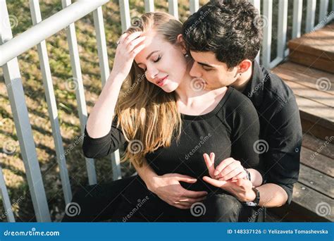 Beautiful Young Multiracial Couple Student Couple In Love Sit Wooden