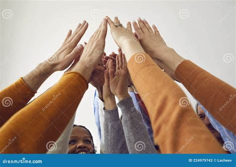 Diverse Team Of Happy Business People Raising Their Arms And Joining