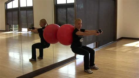 in motion wall ball squat with front raise youtube