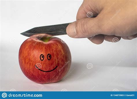 Man Cuts A Red Apple With A Knife Funny Face Image On An Apple Stock