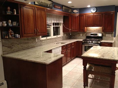 Colonial cream granite is an excellent choice to pair with natural colored cherry cabinets. Soothing Agent: River White Granite Countertops
