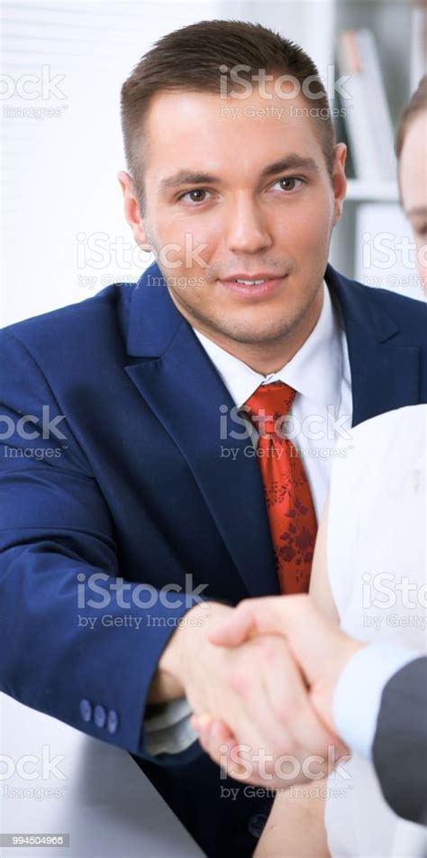 Two Business Man Shaking Hands To Each Other Finishing Up The Meeting