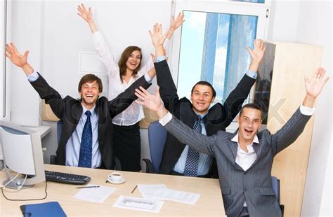 Joyful Business Team In Office Celebrating In Office Stock Photo