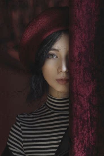Caucasian Woman Peeking From Behind Curtain Photo12 Tetra Images Ivan Ozerov
