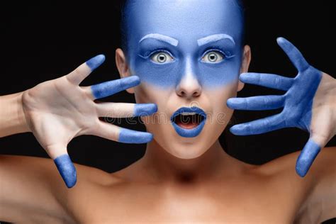 Portrait Of A Woman Who Is Posing Covered With Blue Paint Stock Image