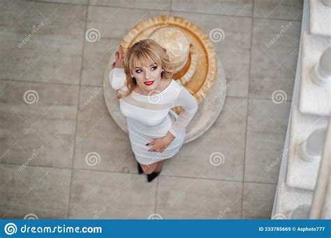 blonde girl on white dress posed on white stairs of hall stock image image of luxurious hair