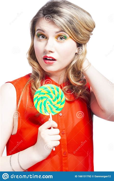 Portrait Of Surprised Caucasian Blond Girl With Sugar Candy Lollipop