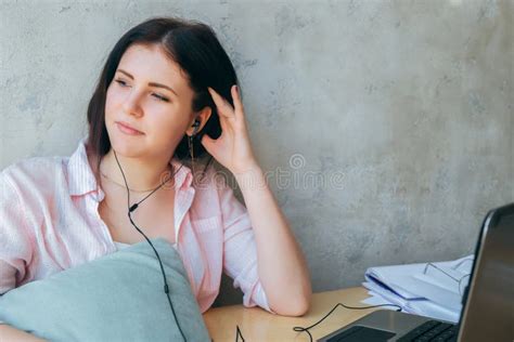 Beautiful Smiling Girl Relaxes Listening To Music On Headphones