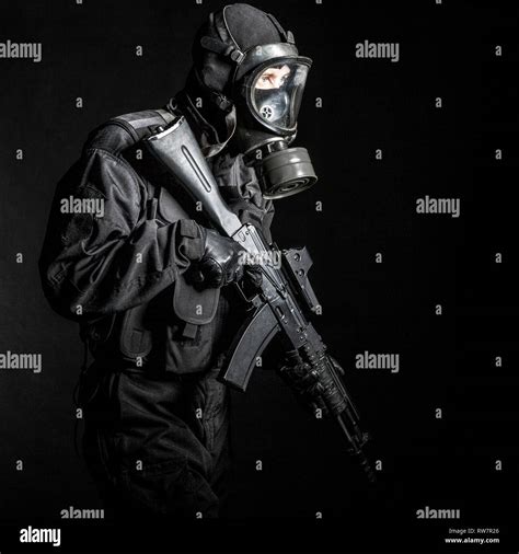 Russian Special Forces Operator In Black Uniform And Gas Mask Stock