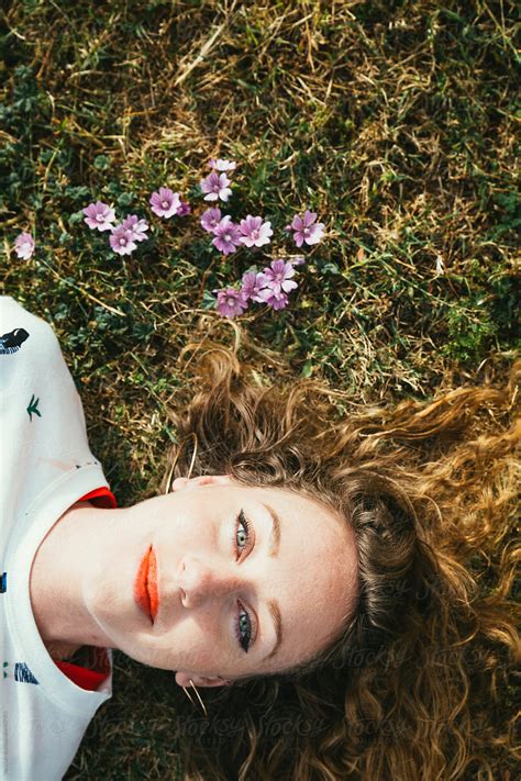 Young Woman Lying In The Grass By Stocksy Contributor Vera Lair