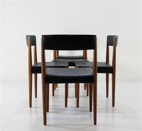 Genuine tanned leather combined with black metal legs, this tub chair is sophisticated elegance redefined. Five teak and black leather Danish design dinner chairs