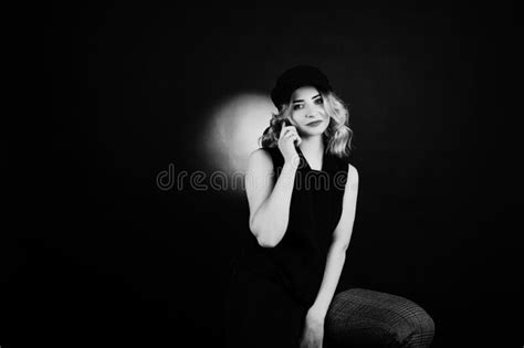 Studio Portrait Of Blonde Girl In Black Wear And Cap Stock Image