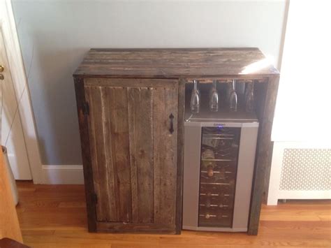 This bar cabinet with wine storage holds up to 18 bottles of wine. My first pallet project. Rustic Liquor cabinet with built ...