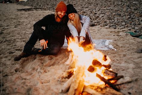 Couple Enjoying Campfire At The Beach By Stocksy Contributor Dylan M