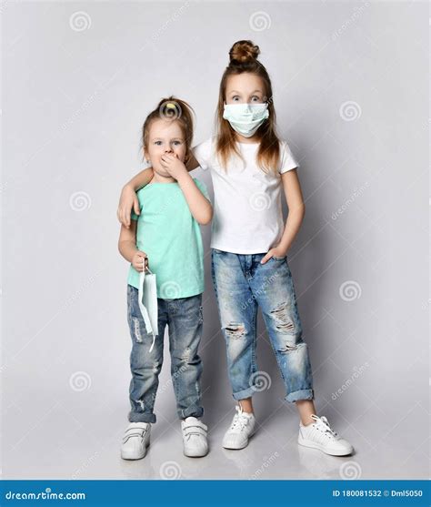 Two Scared Children Girls Kids In Medical Masks From The Coronavirus