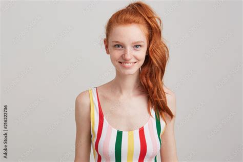 Closeup Of Smiling Attractive Redhead Young Woman With Freckles And