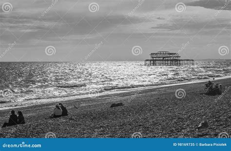 The Old Brighton Pier In Black And White People Chilling On The Beach