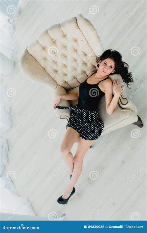 Slender Brunette Lying On A White Armchair Stock Photo Image Of Long