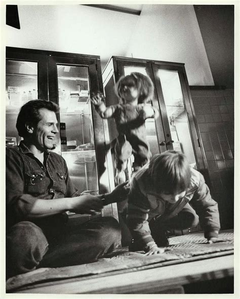 An Old Black And White Photo Of Two Children Playing With A Man In The