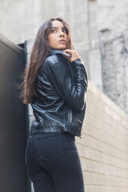 Free Photo Beautiful Young Woman Adjusting Her Leather Collar Jacket