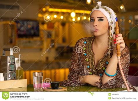Arabian Girl Holding The Hookah Pipe In A Coffee Shop